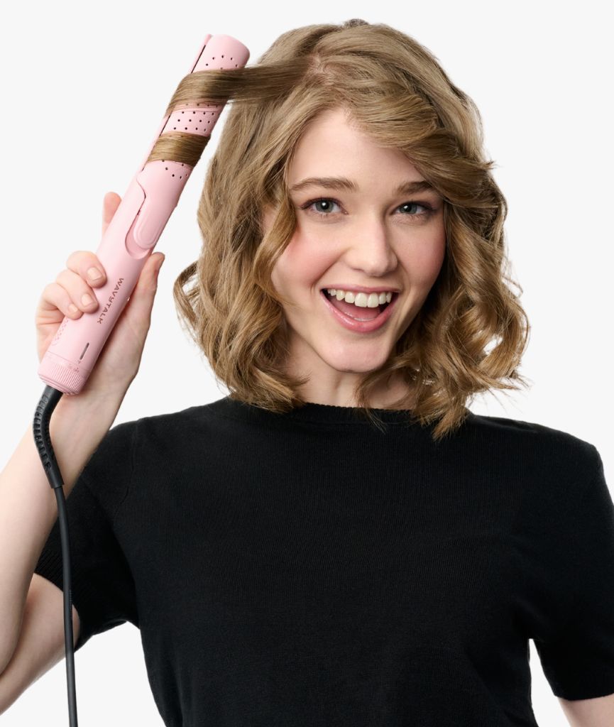 Woman holding a pink hair waver with soft wavy short hair