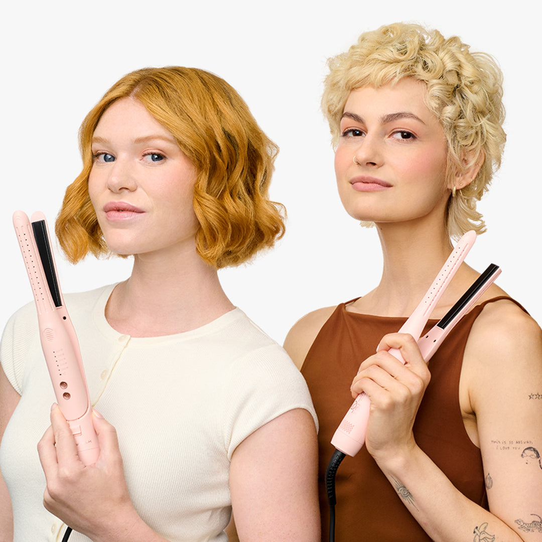 Two women holding pink cool curl pencil against a white background