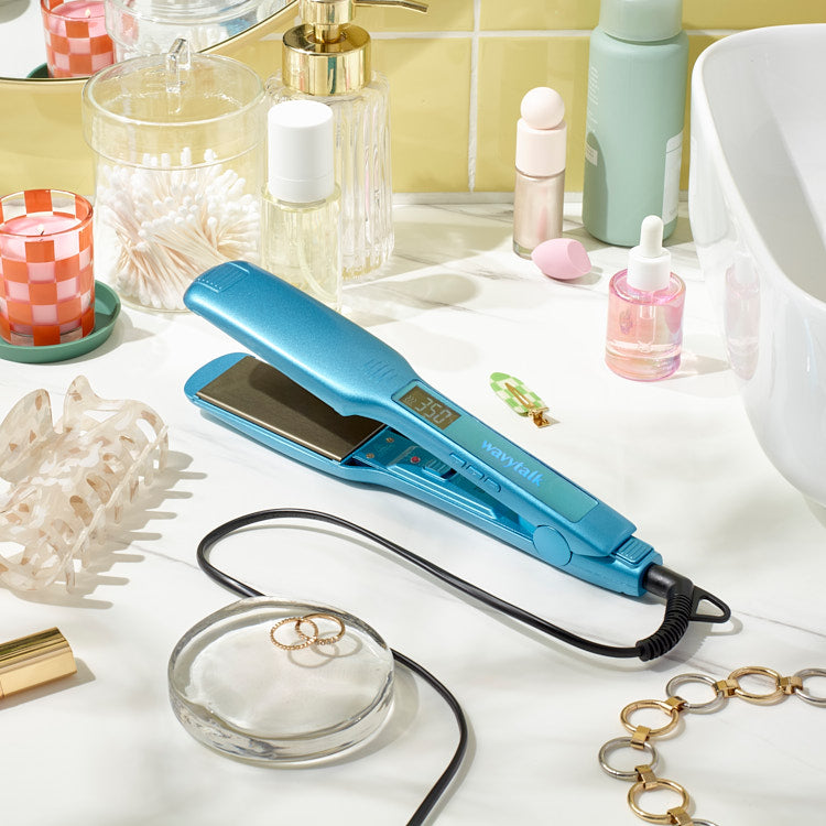 Wavytalk premium blue hair straightener on marble bathroom vanity with beauty accessories and skincare products