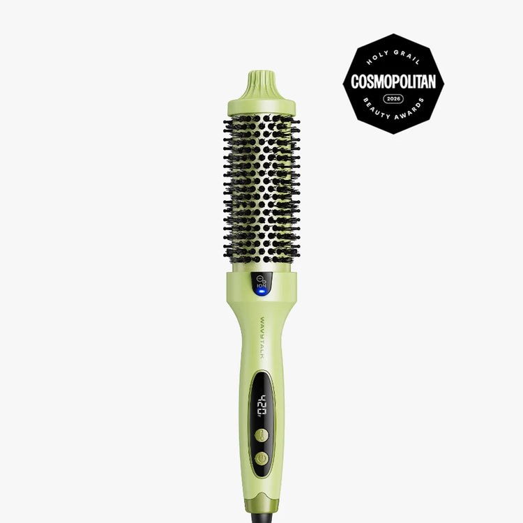 A light green and black round hairbrush styling tool with a digital temperature display, shown on a light gray background with a black Cosmopolitan Beauty Award badge in the top right corner.
