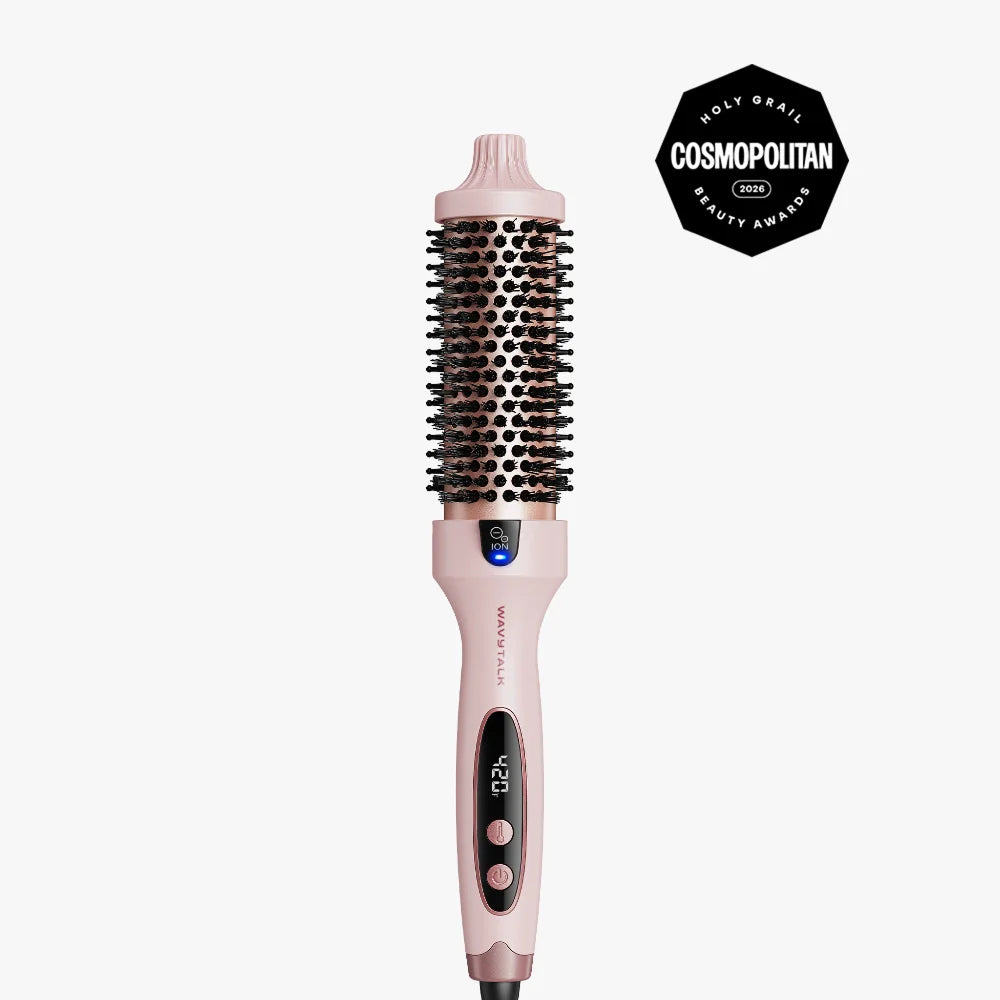 A pink and black round hair styling brush with digital temperature control, shown vertically on a light gray background with a black Cosmopolitan Beauty Awards badge in the top right corner.