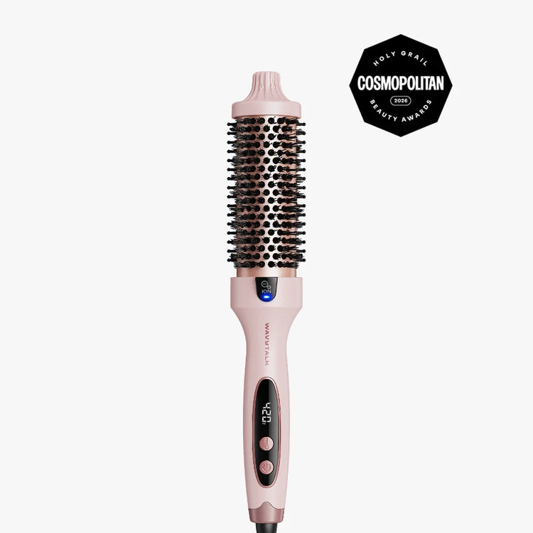 A pink and black round hair styling brush with digital temperature control, shown vertically on a light gray background with a black Cosmopolitan Beauty Awards badge in the top right corner.