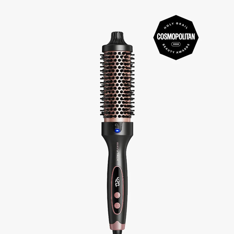 A hot air brush styling tool with a black handle and rose gold barrel, shown vertically against a light gray background with a Cosmopolitan Beauty Awards badge in the top right corner.