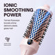 Pink Blowout Boost hair styling tool with blue bristle design on a light purple background, featuring text about ionic smoothing power.