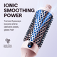 Pink Blowout Boost hair tool with blue bristle head and pink handle on a light gray background, featuring text about ionic smoothing power.
