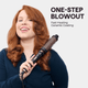 Woman using the Thermal Brush attachment from the Multi Curl 5-in-1 set with text 'One-Step Blowout' on a light gray background