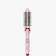 A pink Heatwave Pro 1.5" hair curler with a digital temperature readout.