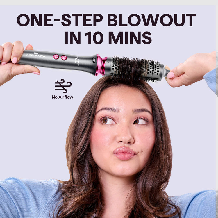 Woman using a grey Blowout Boost hair styling tool with text 'One-Step Blowout in 10 Mins' on a light purple background.