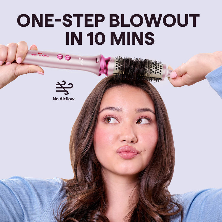 Woman using a Pink Heatwave Pro hair styling tool with text 'One-Step Blowout in 10 Mins' on a light gray background