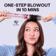 Woman using a Pink Heatwave Pro hair styling tool with text 'One-Step Blowout in 10 Mins' on a light gray background