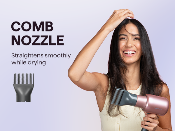 Woman using a hair dryer with a comb nozzle attachment on a light purple background
