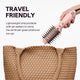 Pink Jet Brush held over a woven brown bag with text about its travel-friendly design.