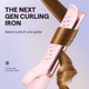 Pink Cool Curl curling iron being used on long blonde hair to create waves, featured against a crisp light blue background.