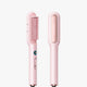 Pink hair straightener with comb attachment on a white background