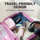 A pink travel-friendly hair styling tool is shown inside an open pink suitcase, surrounded by travel items like jeans, a small pink pouch, headphones, and a wallet. Text on the image reads 'TRAVEL-FRIENDLY DESIGN' and 'Lightweight, compact and dual-voltage' with a badge indicating '100V-240V'.