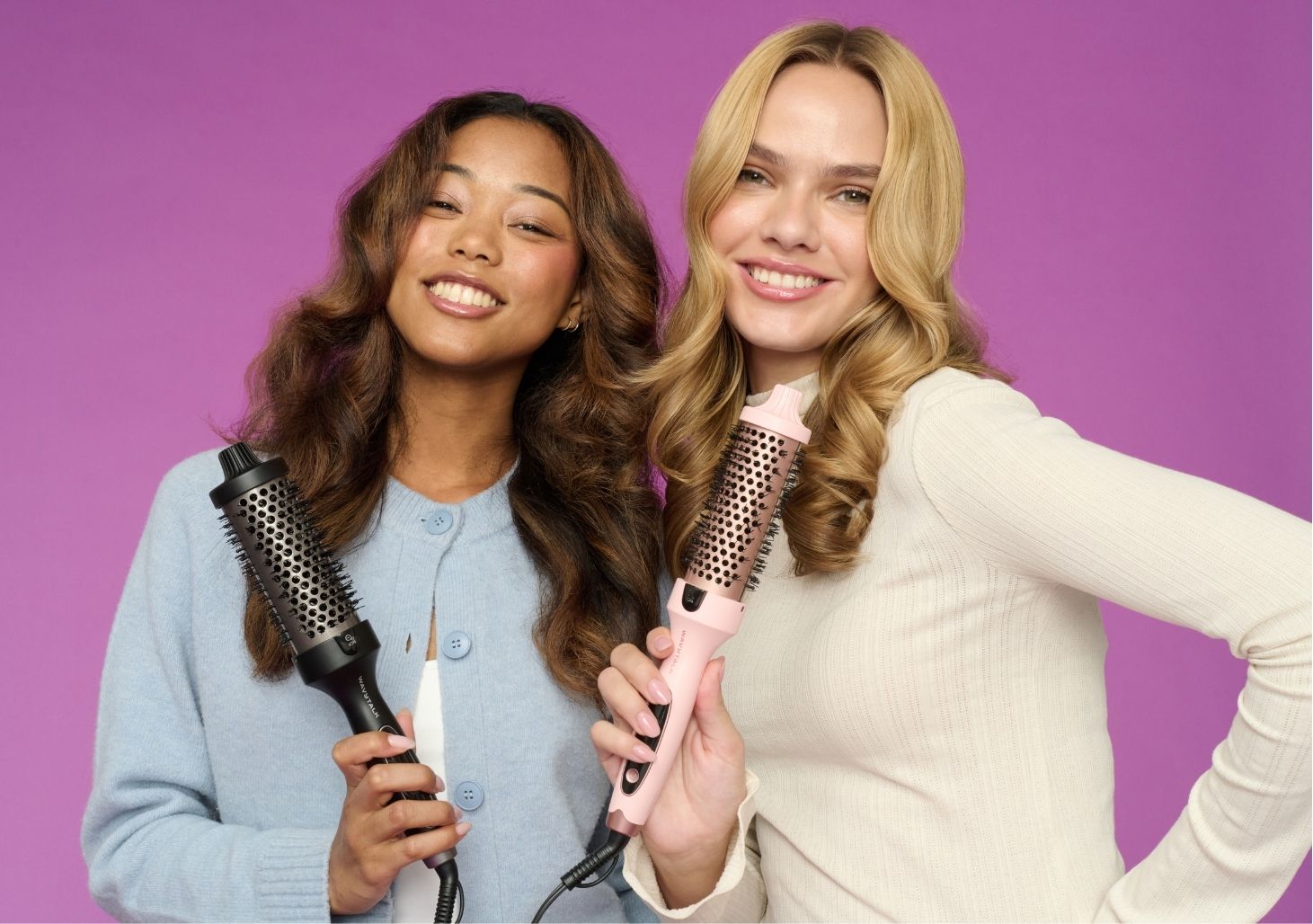 Two women holding Blowout Boost against a purple background